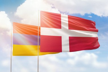 Sunny blue sky and flags of denmark and armenia