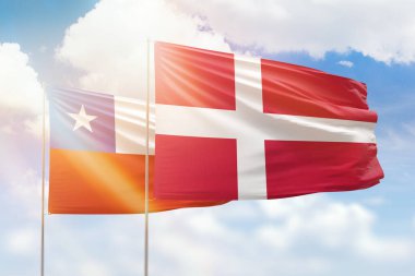 Sunny blue sky and flags of denmark and chile