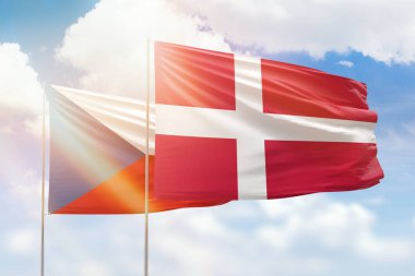 Sunny blue sky and flags of denmark and czechia