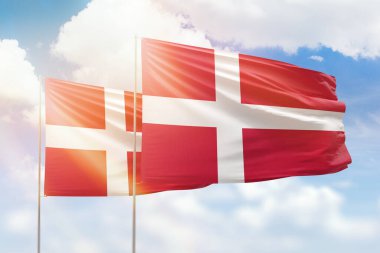 Sunny blue sky and flags of denmark and denmark