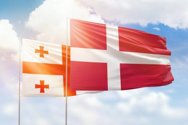 Sunny blue sky and flags of denmark and georgia