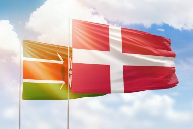 Sunny blue sky and flags of denmark and kenya