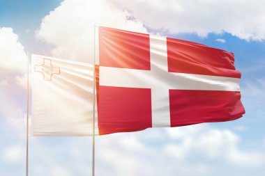 Sunny blue sky and flags of denmark and malta