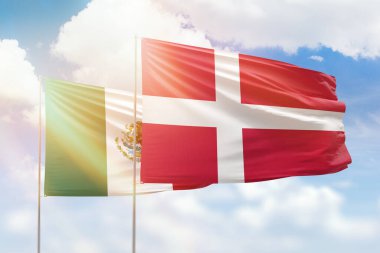 Sunny blue sky and flags of denmark and mexico