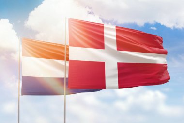 Sunny blue sky and flags of denmark and netherlands
