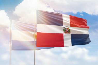 Sunny blue sky and flags of dominican republic and argentina