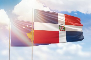 Sunny blue sky and flags of dominican republic and kosovo