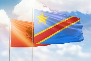 Sunny blue sky and flags of dr congo and albania