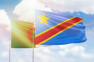 Sunny blue sky and flags of dr congo and algeria