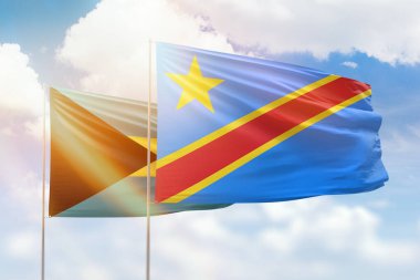 Sunny blue sky and flags of dr congo and bahamas