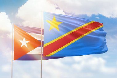 Sunny blue sky and flags of dr congo and cuba