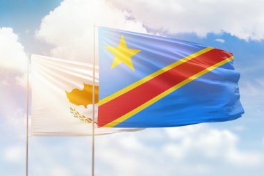 Sunny blue sky and flags of dr congo and cyprus