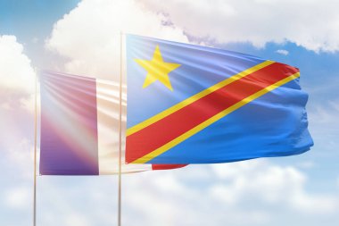Sunny blue sky and flags of dr congo and france