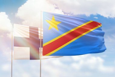 Sunny blue sky and flags of dr congo and finland