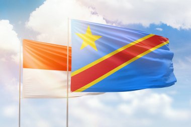 Sunny blue sky and flags of dr congo and indonesia