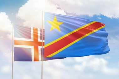 Sunny blue sky and flags of dr congo and iceland