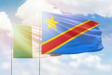 Sunny blue sky and flags of dr congo and ireland