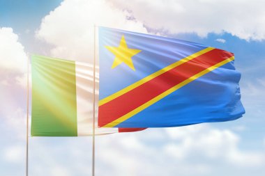 Sunny blue sky and flags of dr congo and italy