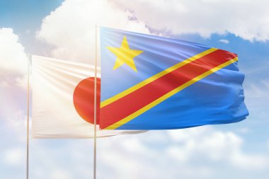 Sunny blue sky and flags of dr congo and japan