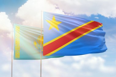 Sunny blue sky and flags of dr congo and kazakhstan