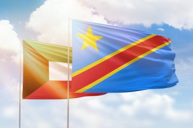 Sunny blue sky and flags of dr congo and kuwait