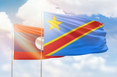 Sunny blue sky and flags of dr congo and laos