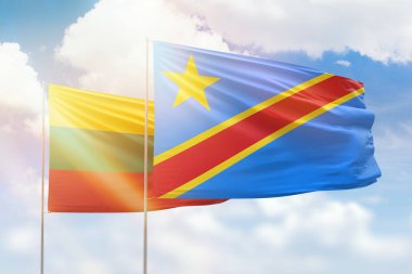 Sunny blue sky and flags of dr congo and lithuania