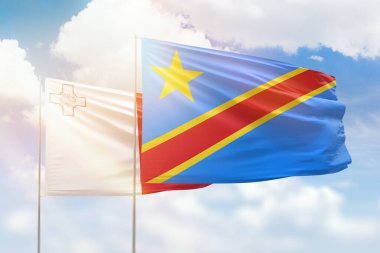Sunny blue sky and flags of dr congo and malta