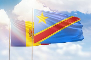 Sunny blue sky and flags of dr congo and moldova
