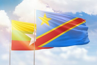 Sunny blue sky and flags of dr congo and myanmar