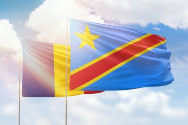 Sunny blue sky and flags of dr congo and romania