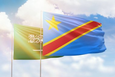 Sunny blue sky and flags of dr congo and saudi arabia
