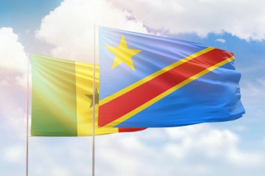 Sunny blue sky and flags of dr congo and senegal
