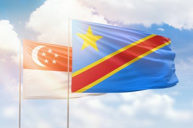 Sunny blue sky and flags of dr congo and singapore