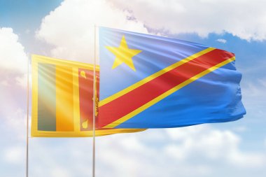 Sunny blue sky and flags of dr congo and sri lanka