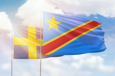 Sunny blue sky and flags of dr congo and sweden