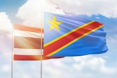 Sunny blue sky and flags of dr congo and thailand