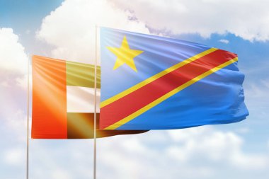 Sunny blue sky and flags of dr congo and uae