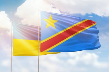 Sunny blue sky and flags of dr congo and ukraine