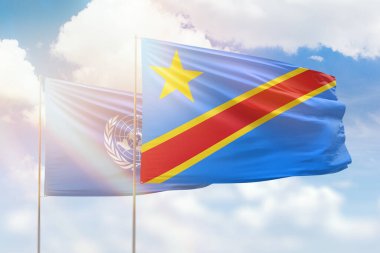 Sunny blue sky and flags of dr congo and united nations