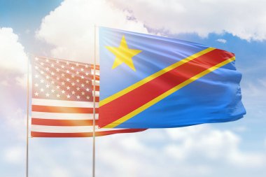 Sunny blue sky and flags of dr congo and usa