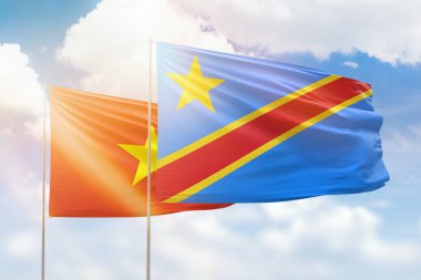 Sunny blue sky and flags of dr congo and vietnam