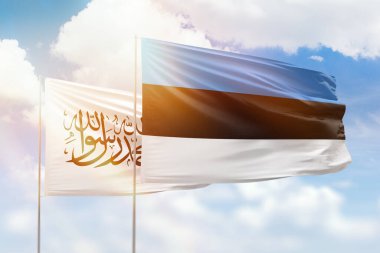 Sunny blue sky and flags of estonia and afghanistan