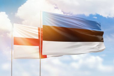 Sunny blue sky and flags of estonia and england