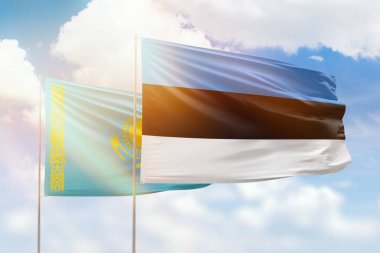 Sunny blue sky and flags of estonia and kazakhstan