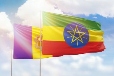 Sunny blue sky and flags of ethiopia and andorra
