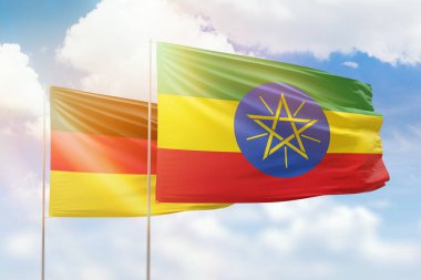 Sunny blue sky and flags of ethiopia and germany