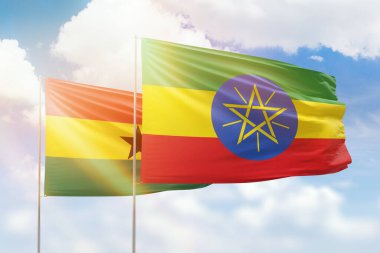Sunny blue sky and flags of ethiopia and ghana