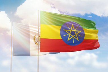 Sunny blue sky and flags of ethiopia and guatemala