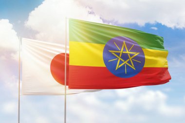 Sunny blue sky and flags of ethiopia and japan